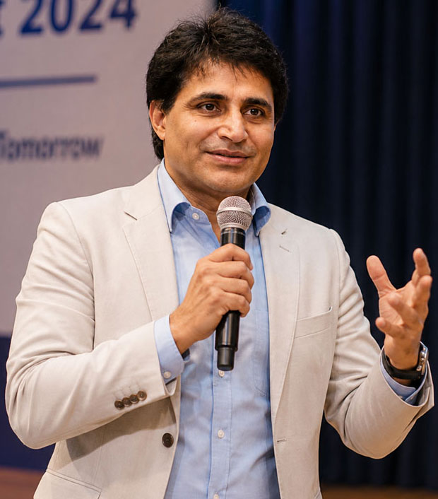 Sumit Malhotra speaking on a campus stage
